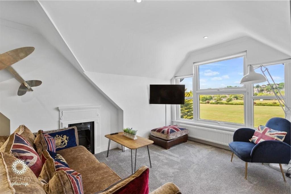 a living room with a couch and a window at The Lookout in Hythe