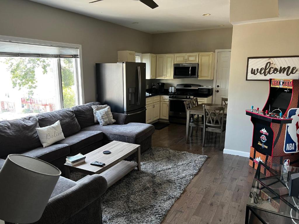 a living room with a couch and a kitchen at Chelsea Condo’s in Chelsea