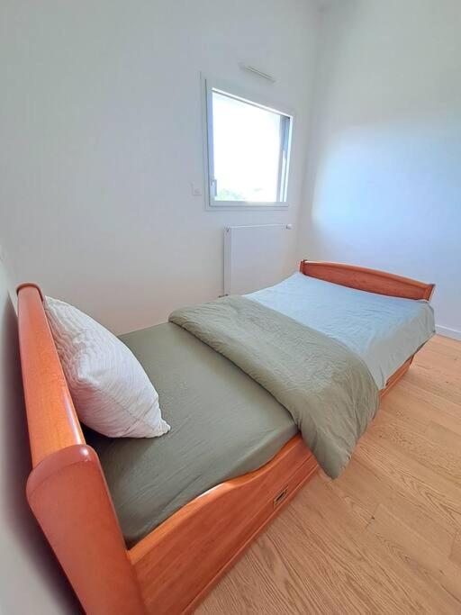 a bed in a white room with a window at Maison de vacances à Loctudy in Loctudy