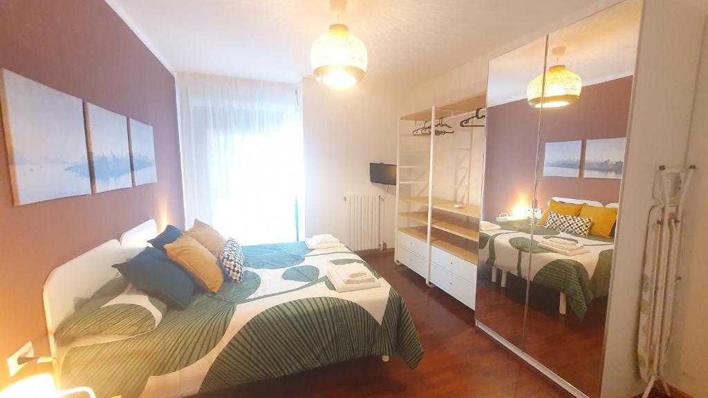 a small bedroom with a bed and a mirror at RomagnaBNB Nereo in Forlì