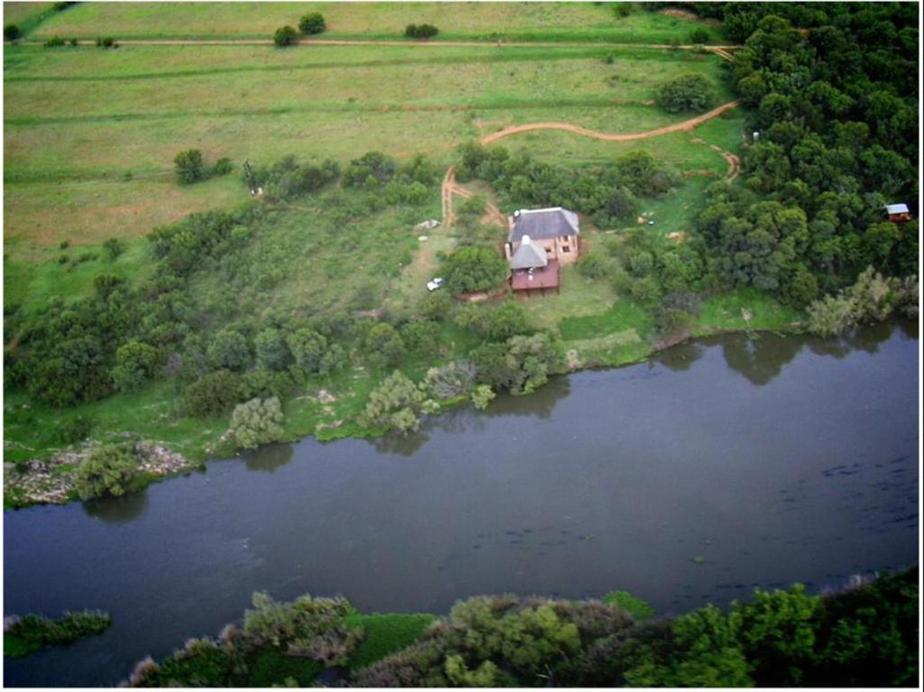 an aerial view of a house next to a lake at Schoemanshof in Potchefstroom