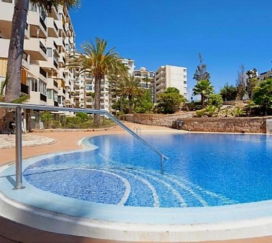 an empty swimming pool in the middle of a city at Eldorado Emily 1 Bedroom Sea view in Playa de las Americas