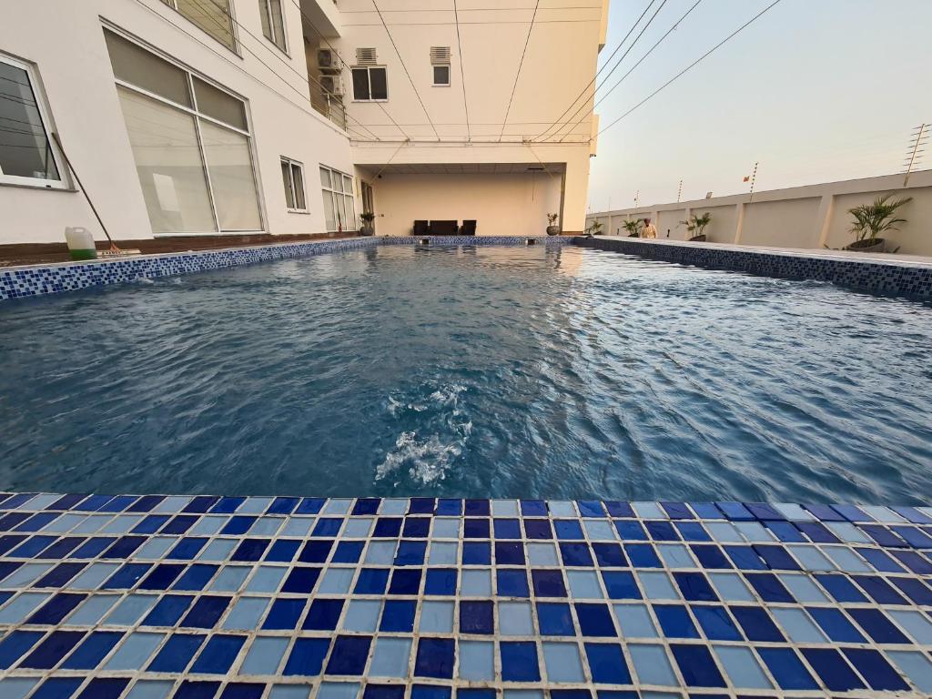 a swimming pool in the middle of a building at 1 Bed Modern Apartment, Pool, Gym, Cinema in Lahore