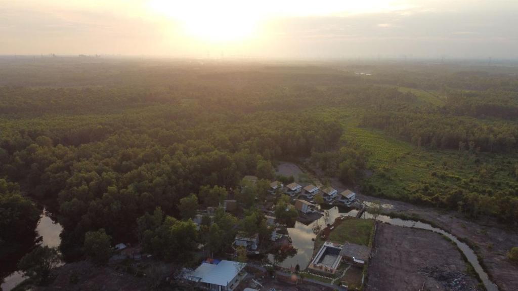 an aerial view of a house in a forest at TimeOut Island Glamping Resort in Ấp Binh Trung