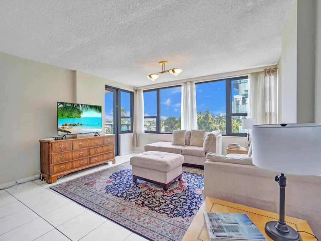 a living room with a couch and a tv at Beachfront Ocean View Condo Beach Service 520 in Miami Beach