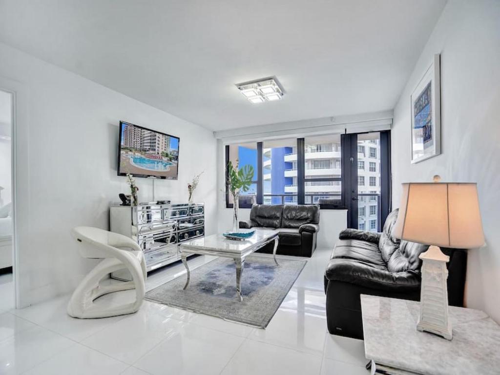 a living room with a couch and a table at Beachfront Condo w Beach Service 1207 in Miami Beach
