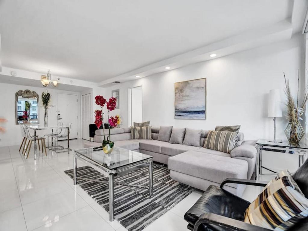 a living room with a couch and a table at Amazing Ocean View Condo Beach Service 1111 in Miami Beach
