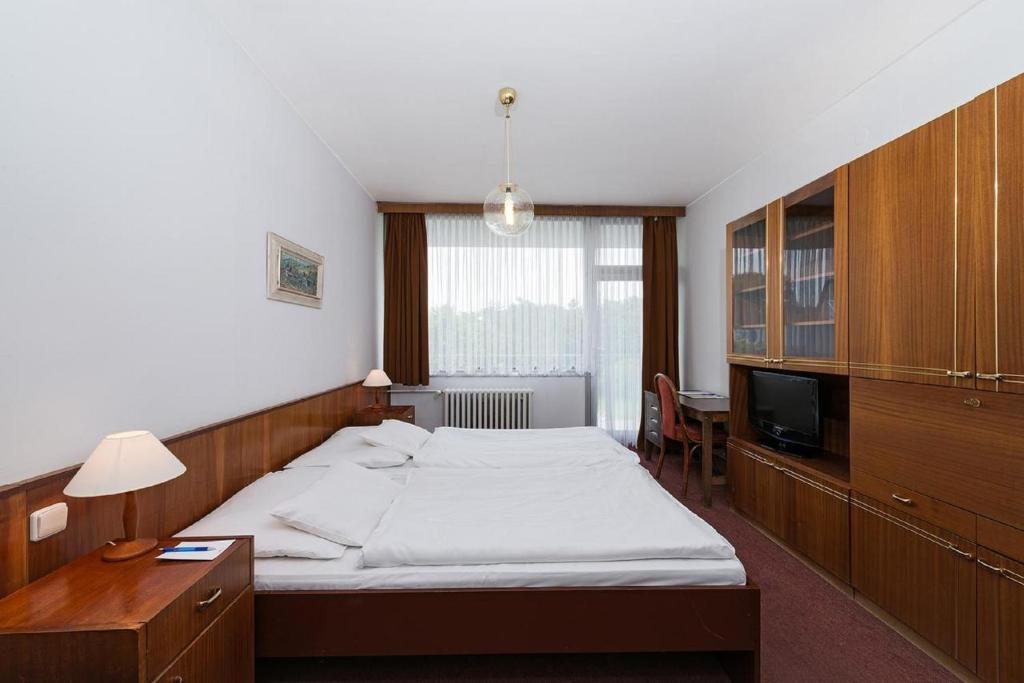 Postel nebo postele na pokoji v ubytování Ensana Splendid