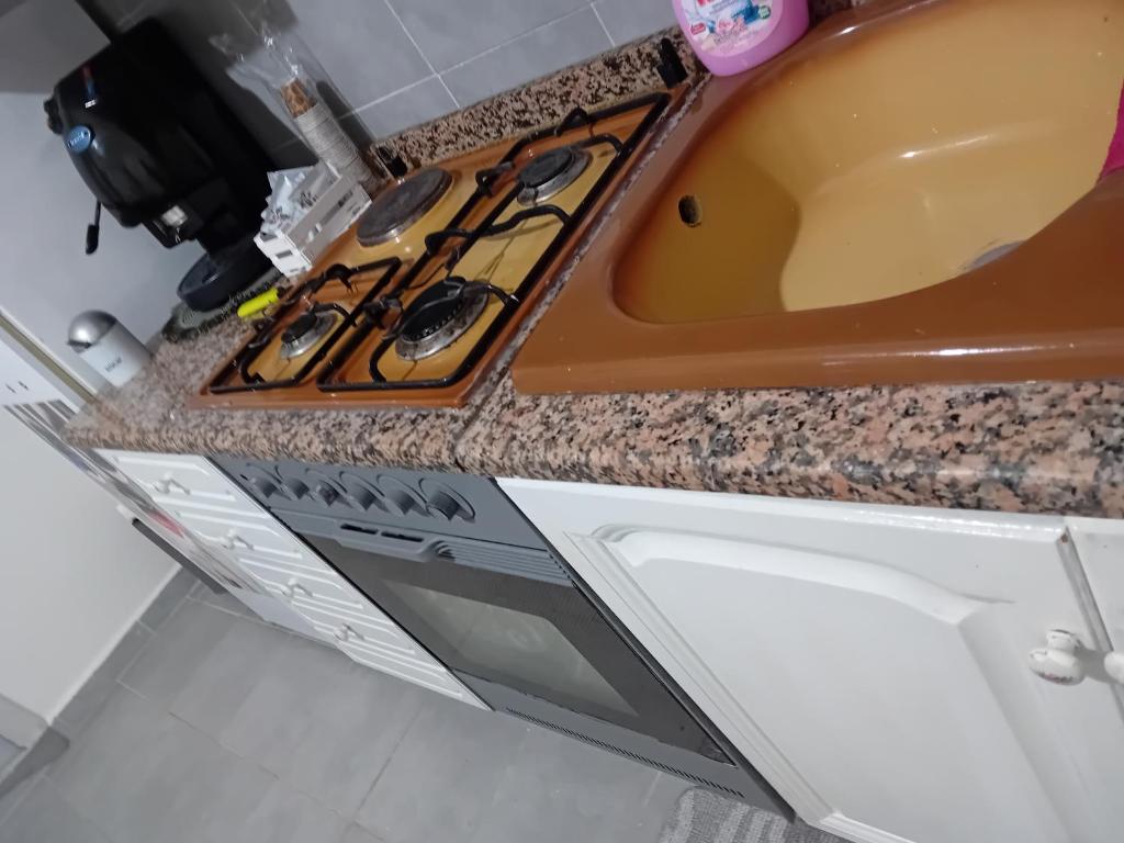 eine Küchentheke mit einer Spüle und einer Mikrowelle in der Unterkunft Casa Passamonte in Palermo