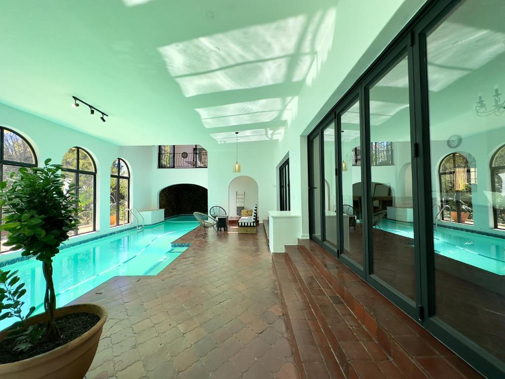 a large swimming pool in a house at Riverside House with Indoor Pool in Johannesburg
