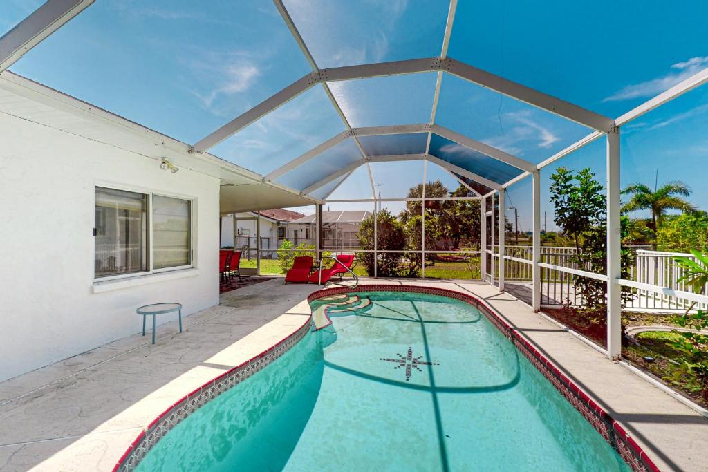 an indoor swimming pool in a house with a glass roof at Port of Call in Port Charlotte