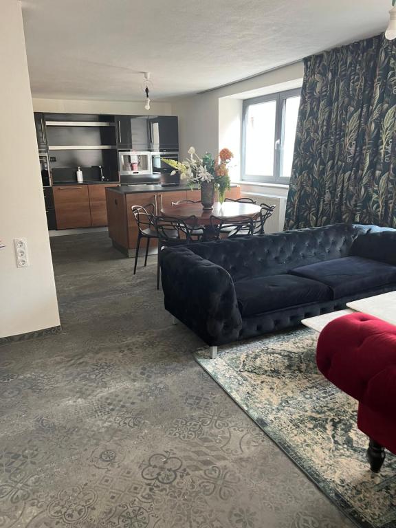 a living room with a couch and a table at Your dream flat in Vohenstrauß