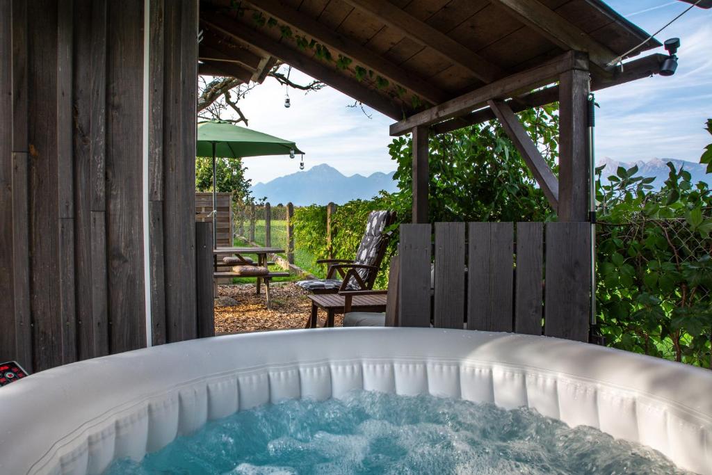 a hot tub in the backyard of a house at Glamping with a view in Smlednik