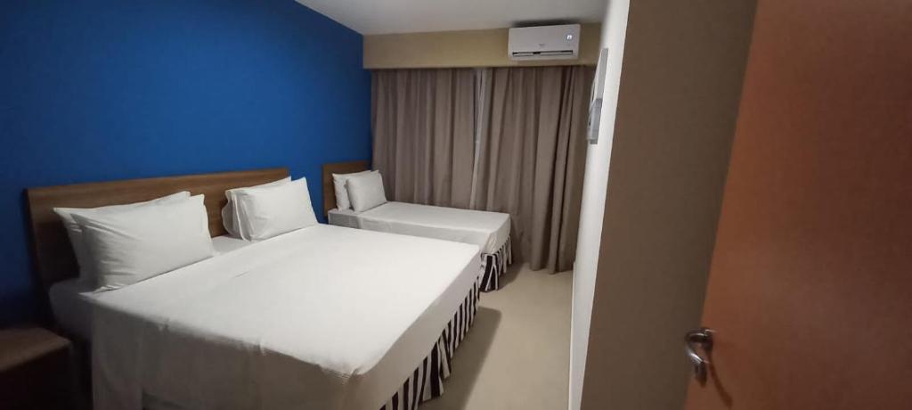 a small room with two beds and a chair at Enjoy São Pedro Thermas Resort in São Pedro