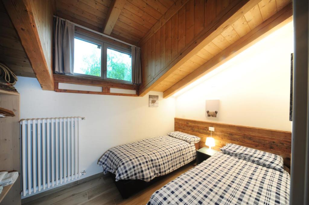 Postel nebo postele na pokoji v ubytování Appartamenti Residence Lares Ossana