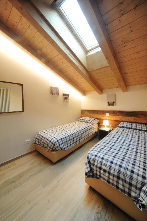 Postel nebo postele na pokoji v ubytování Appartamenti Residence Lares Ossana