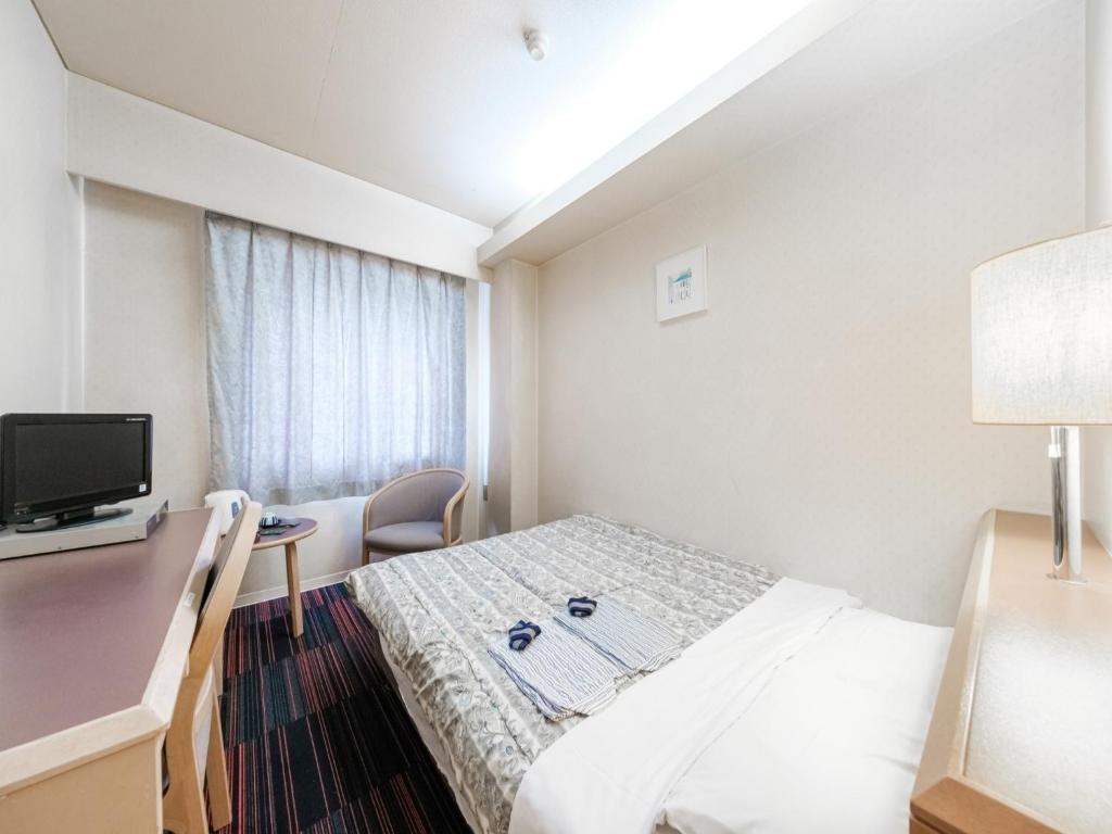 札幌市にあるHotel Tetora Spirit Sapporo - Vacation STAY 59365vのベッドとデスクが備わるホテルルームです。