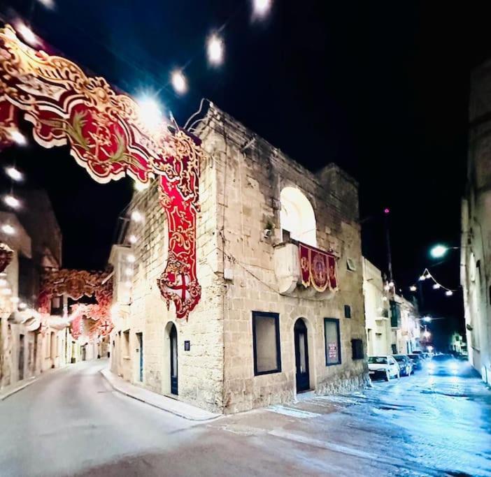 a building on a street at night with lights at Town House 91 in Victoria