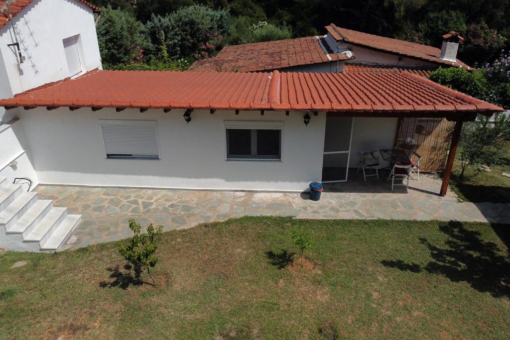 an aerial view of a house with a red roof at Dimitra's Country House in Forest and Sea (2) in Metamorfosi