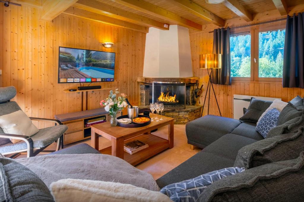 a living room with a couch and a fireplace at Chalet Igel - OVO Network in Châtel