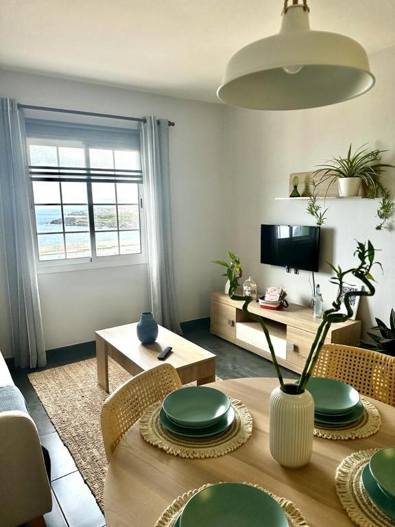 a living room with a table with green plates on it at La Casita de Daise in Garachico