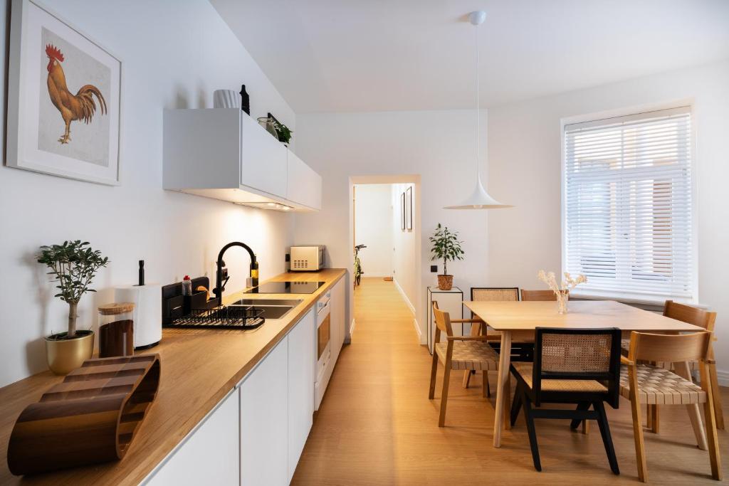 a kitchen and dining room with a table and chairs at Tina's Riga apartments in Rīga