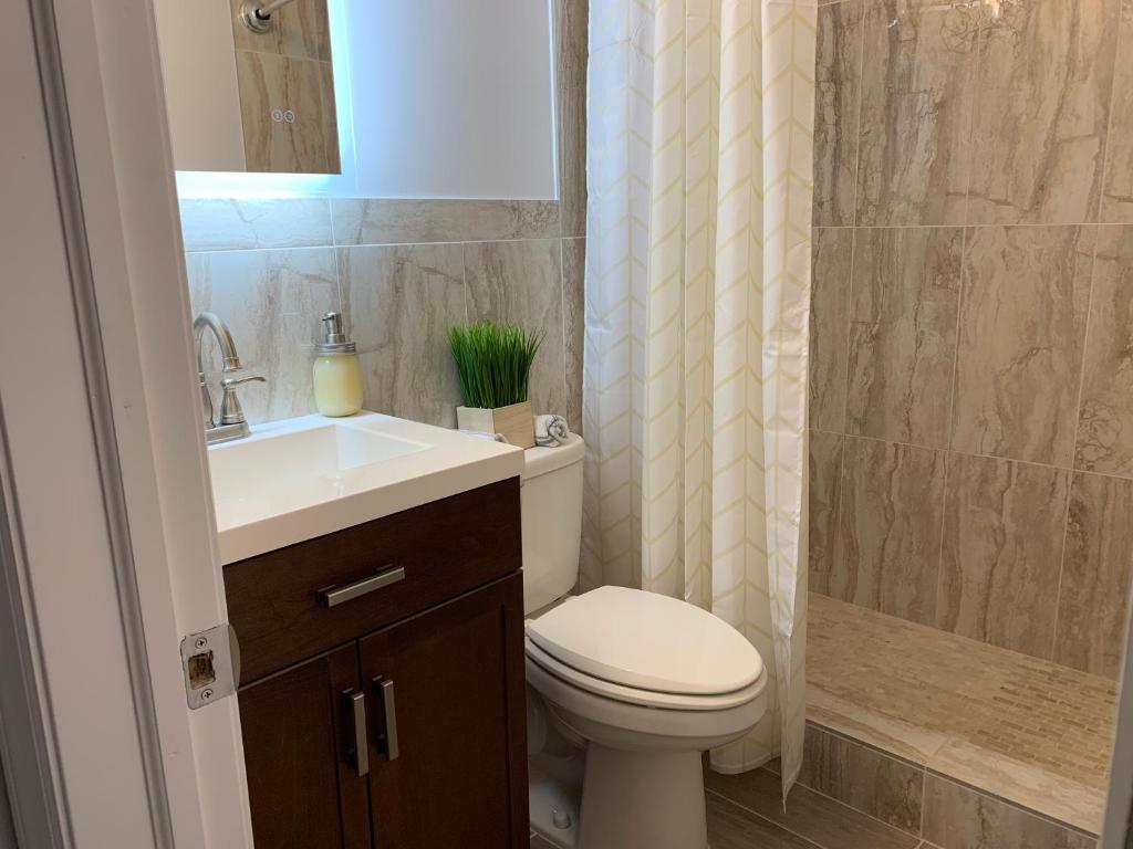 a bathroom with a toilet and a sink and a shower at Brooklyn Studios By The Beach in Brooklyn