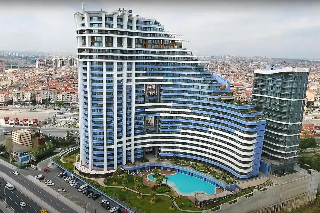 a large building with a pool in front of it at Ottomare Apartments in Istanbul