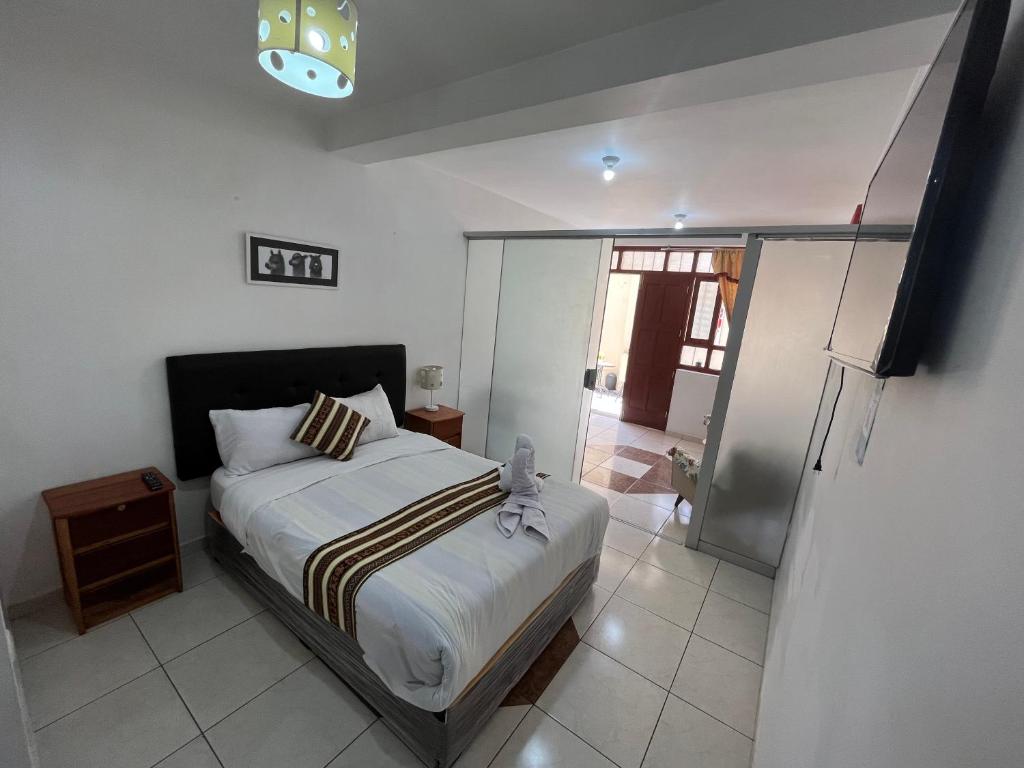Ένα ή περισσότερα κρεβάτια σε δωμάτιο στο Cusco Rooms