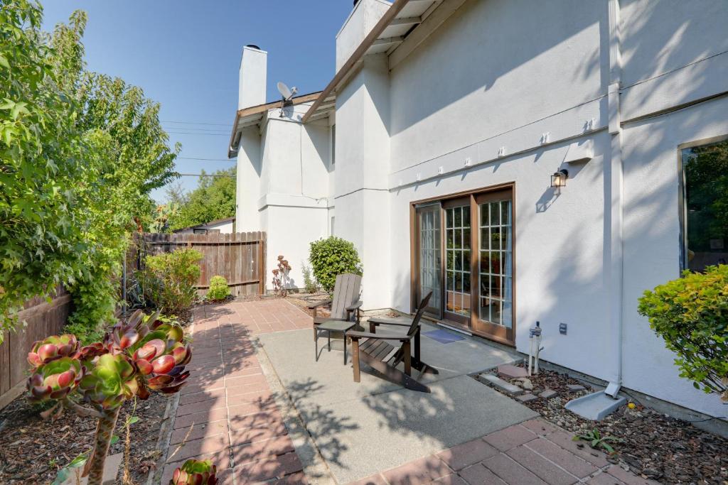 a patio with a wooden bench next to a building at Modern Sacramento Townhome with Patio! in Sacramento