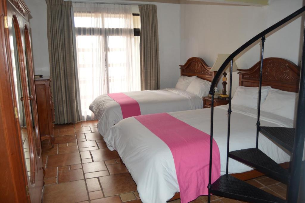 Postel nebo postele na pokoji v ubytování Hotel Meson del Mar