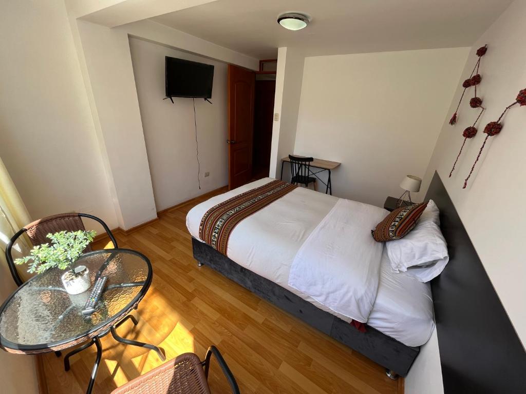 Ένα ή περισσότερα κρεβάτια σε δωμάτιο στο Cusco Rooms