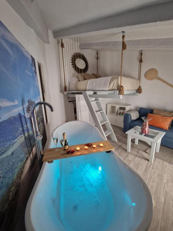 a bathroom with a bath tub and a bunk bed at El Pitijopo in El Gastor