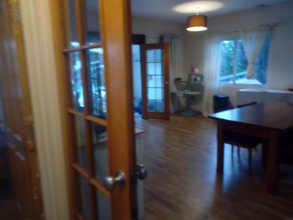 a living room with a table and a dining room at caranavilla in Anse Etoile