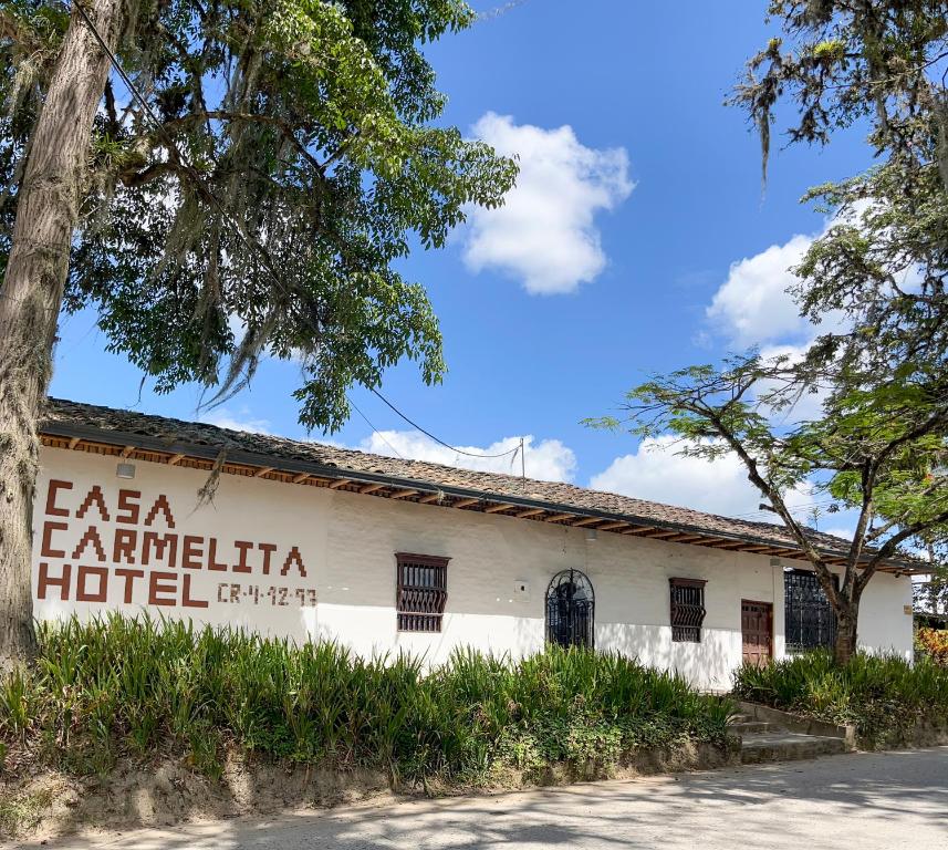 a building with a sign that reads la familia hoteliven at Casa Carmelita Hotel Boutique Pitalito in Pitalito