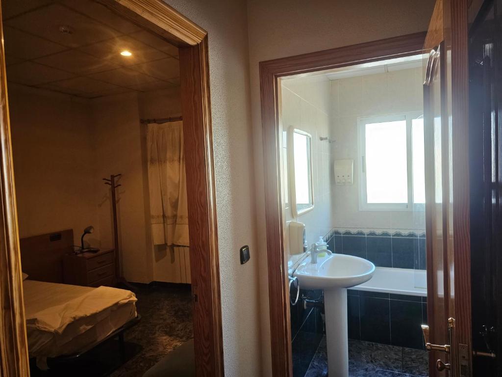 y baño con lavabo y bañera. en Hotel restaurante Palacio Fes en Murcia