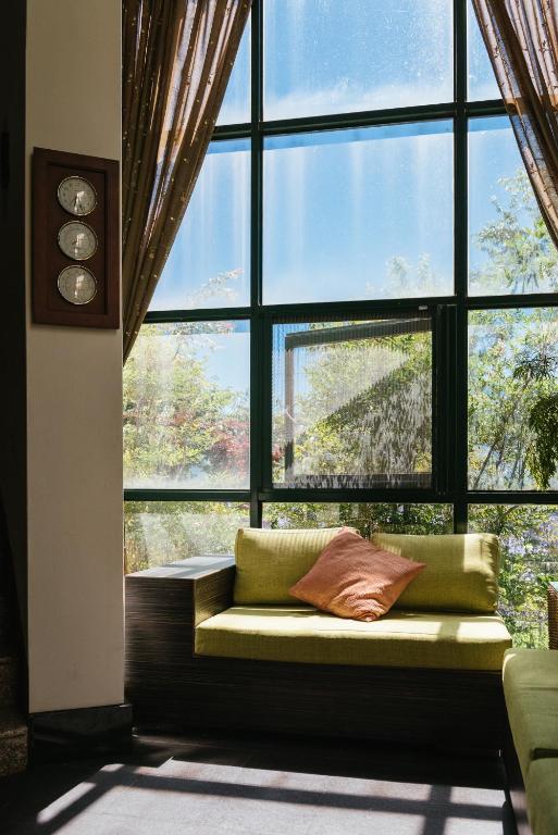 a large window with a couch in front of it at Yun Wu B&amp;B in Ren&#39;ai