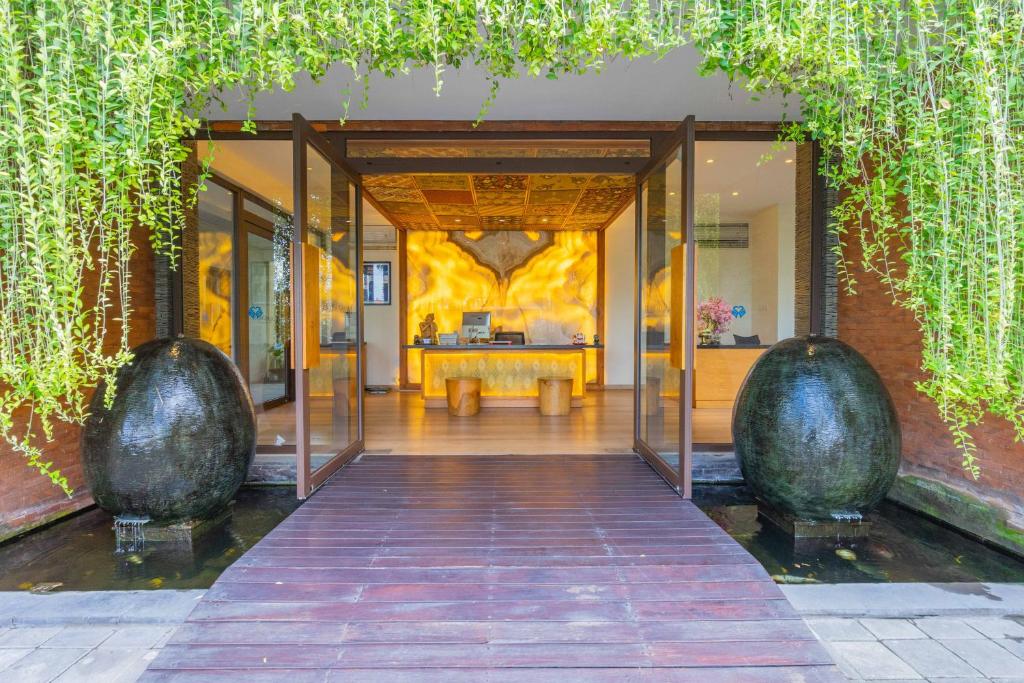 an entrance to a building with glass doors at Lalasa Villas Canggu in Canggu