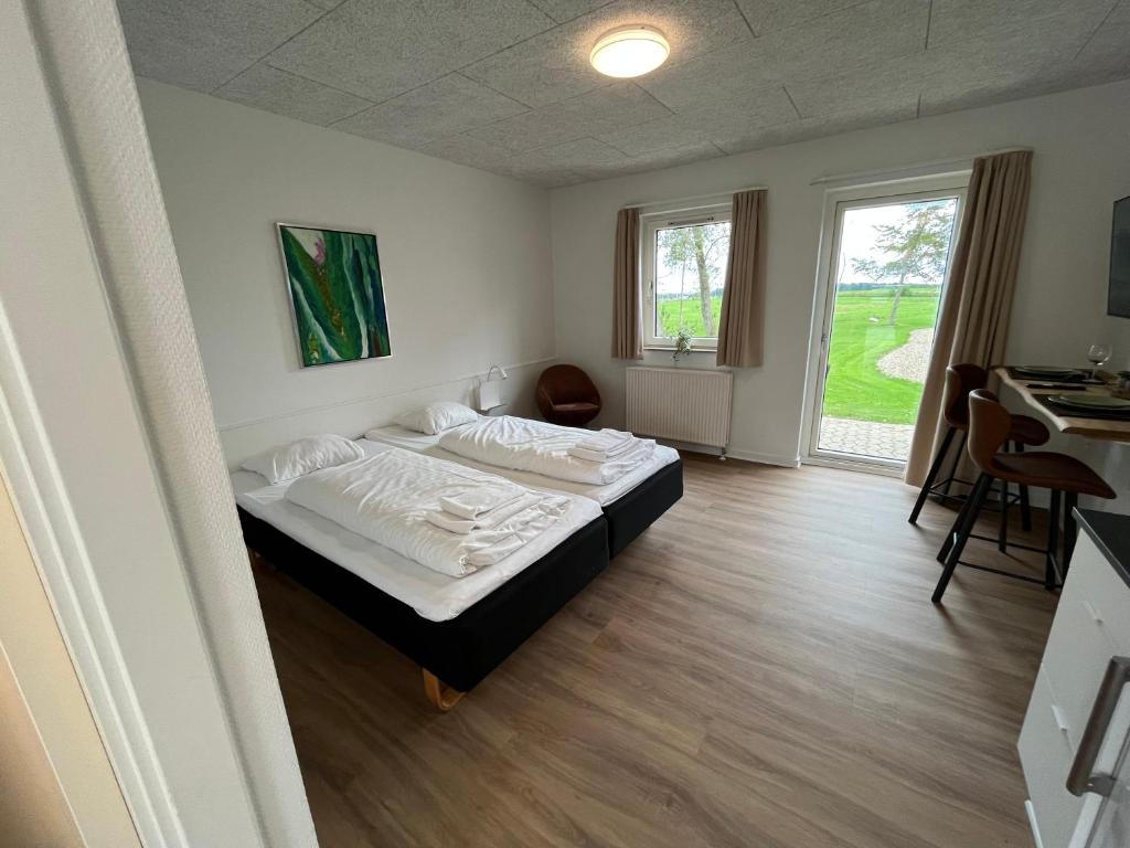 a bedroom with a bed and a desk in it at Go-Sleep Bredehus in Bredsten