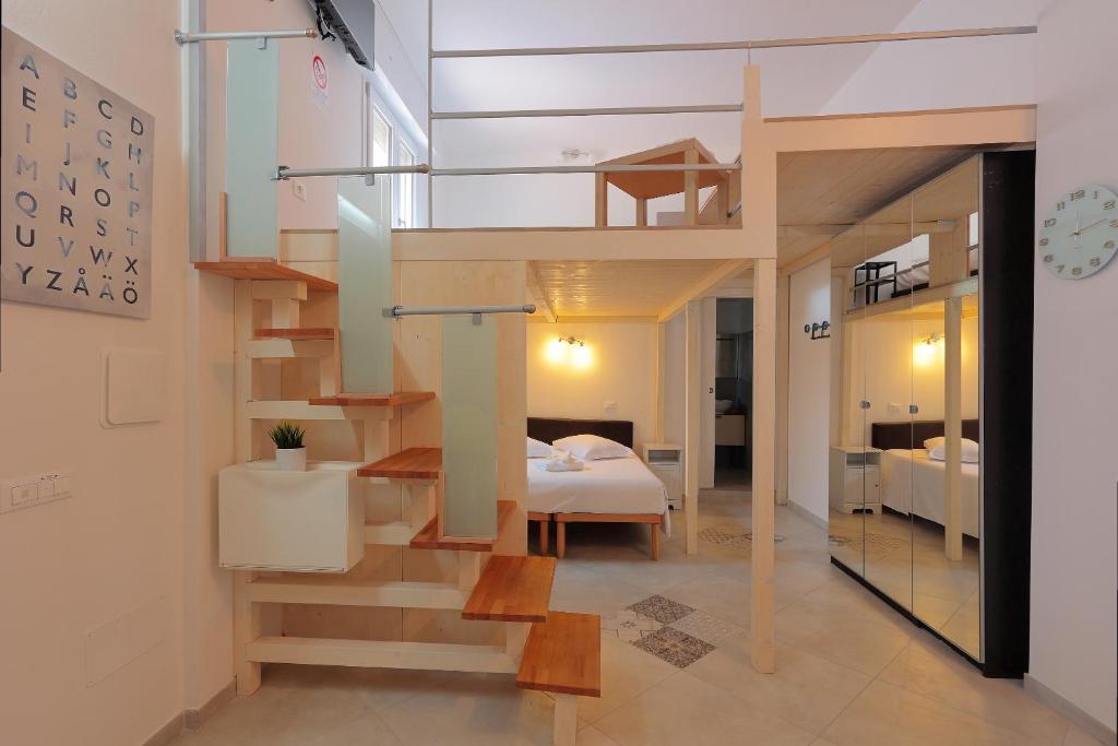 a room with a loft bed and a bedroom at La Ca' Fiera Affittaly Apartments in Bologna