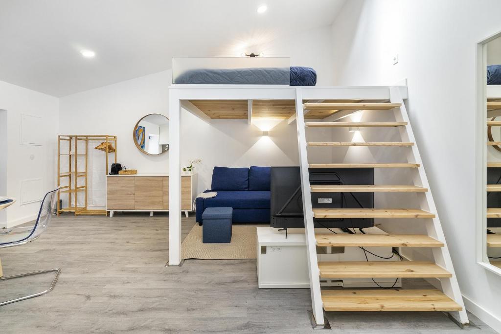 a room with a bunk bed and a desk at WHome Urban Escape: 1-BR w/mezzanine near Campo Ourique in Lisbon