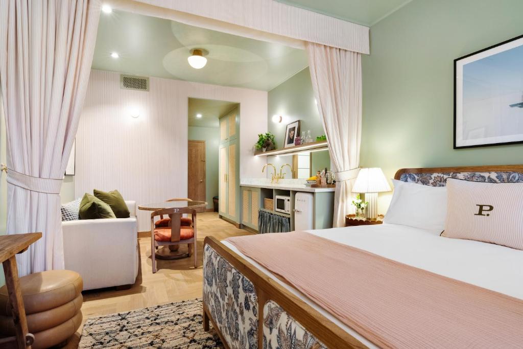 a bedroom with a bed and a living room at Palihouse Hyde Park Village in Tampa