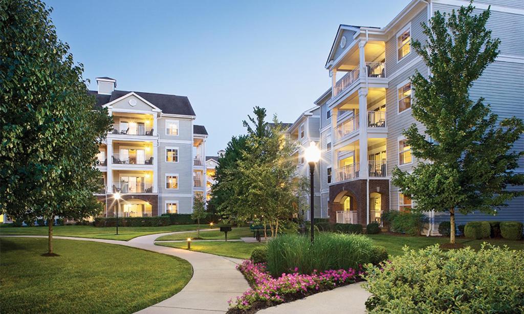 a large apartment building with a walkway in a park at 2 Bedroom Deluxe Villa at the Wyndham Nashville Resort in Nashville