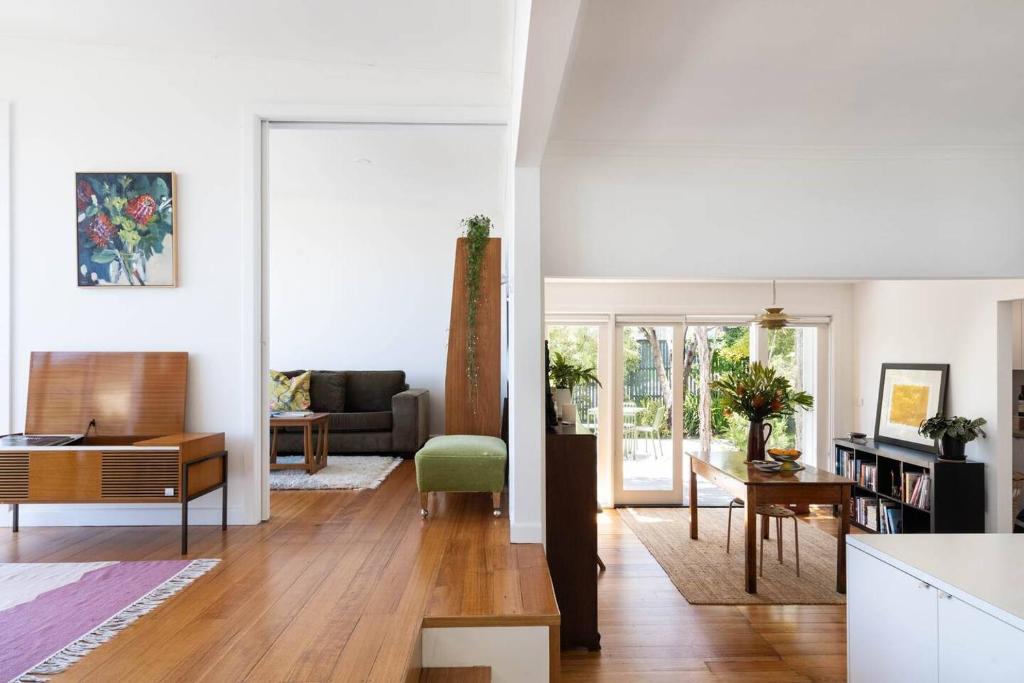 a living room with a couch and a table at Couples Corner - A Stylish Bay View Retreat in McCrae