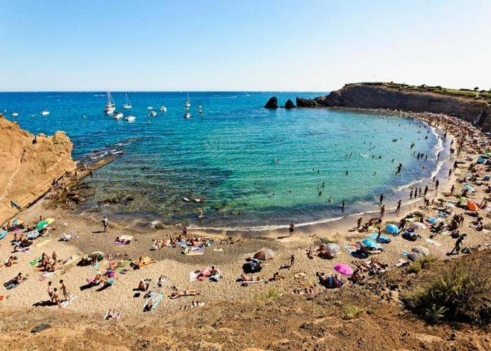 a group of people on a beach in the water at Camping Carabasse Vias plage. in Vias