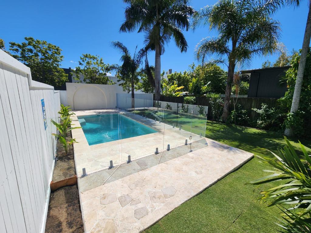 una piscina en un patio junto a una valla en Classic Brisbane Queenslander with Pool & Yard en Brisbane