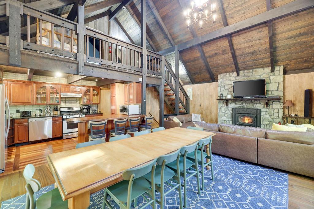 a kitchen and living room with a table and a couch at ⛰⛵️⛱Mt. Maplewood Lodge❤️Seasonal Specials ☆Poconos☆Cabin☆Hot⛷Tub☆Game Room☆ in Pocono Pines