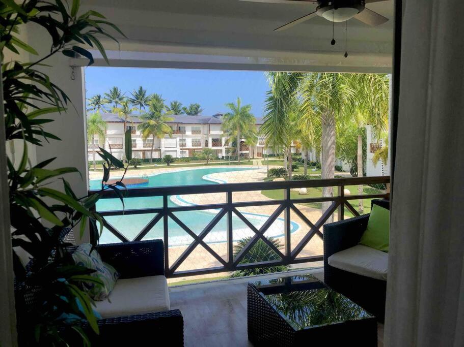 a balcony with a view of a swimming pool at Riviera Azul Playa Dorada in San Felipe de Puerto Plata