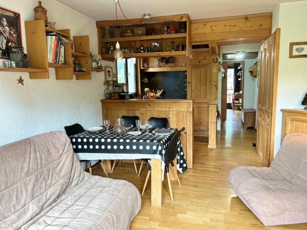 a living room with a table with a polka dot table cloth at Appartement Les Gets, 2 pièces, 4 personnes - FR-1-623-256 in Les Gets