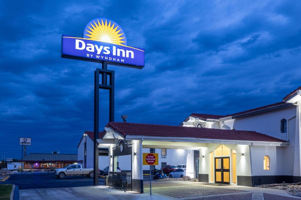 a sign for a days inn at night at Days Inn by Wyndham Casper in Casper